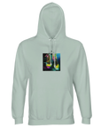 A creamy green hooded sweatshirt featuring a square art print on the front with a colorful, artistic illustration of high-heeled shoes on a textured background.
