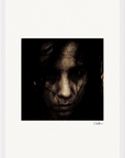 A grainy, sepia-toned close-up of a person’s face with long hair partially covering their features, set against a white background with a signature in the lower right corner—ideal as a fine art print for conscious interior design.