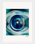 A close-up image of the front window of an Electrolux washing machine features reflections and blue-tinted light effects, with an abstract circular pattern—perfect as mindful home decor or an inspirational wall art fine art print.