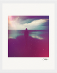 A silhouetted person stands by a calm body of water under a cloudy sky, enhanced by a colorful, hazy filter and visible light flares. This inspirational wall art features a white border and a signature at the bottom right.