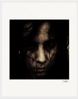 A dark, grainy close-up image of a person with long hair partially covering their face, staring intensely at the camera. Ideal for conscious interior design, this piece features a signature in the lower right corner of the white border.
