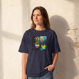 Adventurous - "Dancing in Colours" French Navy T-shirt worn against a sunlit plaster wall
