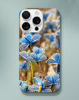 A smartphone with a case featuring a photo art close-up of several blue butterflies on flowers. The word INTENTION and a small circular design are printed near the bottom, highlighting delicate textures in the artwork.