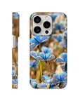 A smartphone case featuring photo art of blue butterflies on grass, highlighted with rich textures. The word INTENTION is printed at the bottom of the back view. Shown from the side and back.