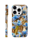 A phone case showcasing a photo art close-up of blue butterflies resting on plants in a field, with the word INTENTION and a small circular logo near the bottom. Subtle textures add depth to this unique design.