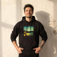 Harmonious - "Underwater Flight" Black Hoodie worn against a sunlit plaster wall