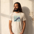 Jazzy - "Lacey Leg" Off White T-shirt worn against a sunlit plaster wall