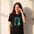 Joy - "Dancing Cowboy" Deep Black T-shirt worn against a sunlit plaster wall