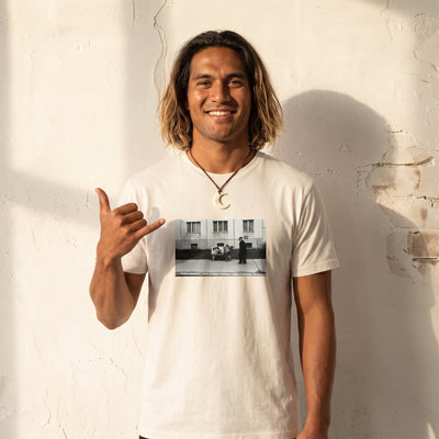 Oneness - "The Urban Matrix" Off White T-shirt worn against a sunlit plaster wall