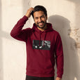 Patience - "This is Where He Stood" Burgundy Hoodie worn against a sunlit plaster wall