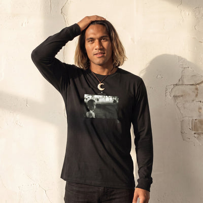 Presence - "Cuba Girl" Deep Black Long Sleeve worn against a sunlit plaster wall