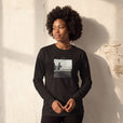 Transcendence - "Ready to Fly" Deep Black Long Sleeve worn against a sunlit plaster wall