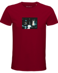 A burgundy short-sleeve t-shirt with a small, rectangular art graphic of a blurry figure and cars on the chest. "Abundance" is printed at the neckline, making this mindful piece both unique and expressive.