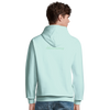 A person is shown from behind wearing a light blue hooded sweatshirt with the word Adventurous on the back—a nod to conscious fashion. The individual has short brown hair and pairs the look with blue jeans.