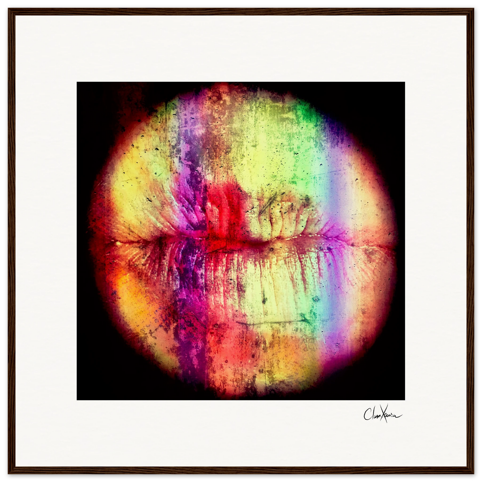 A digital artwork of lips in a dark wood circular frame, showcasing vibrant multicolored streaks on a black background. Signed at the bottom right, this framed wall art is ideal for conscious interior design.