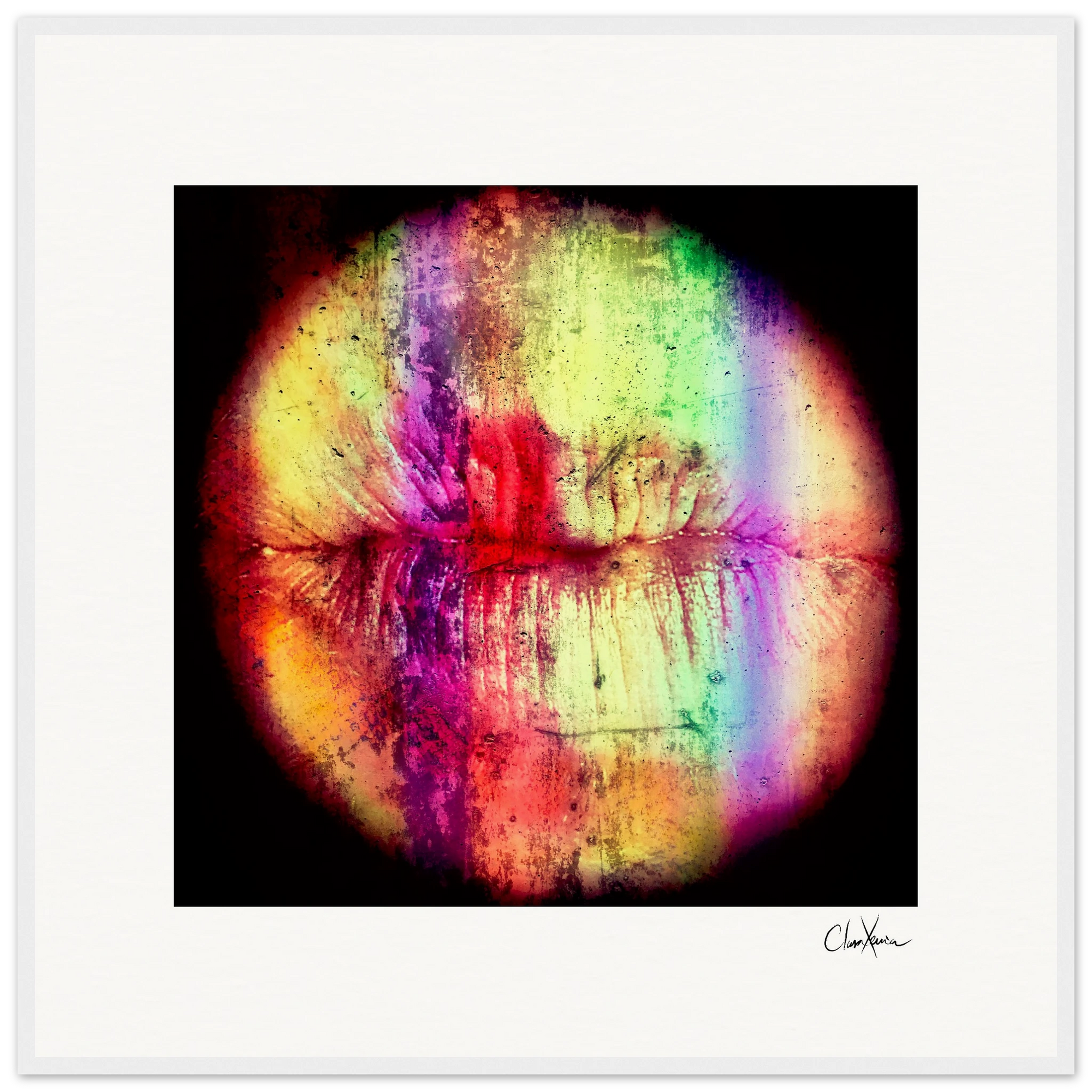 A close-up of lips in vibrant colors and textures forms a circular, abstract design on a white background. Finished with a white frame, this inspirational wall art features the artist's signature in the bottom right corner.