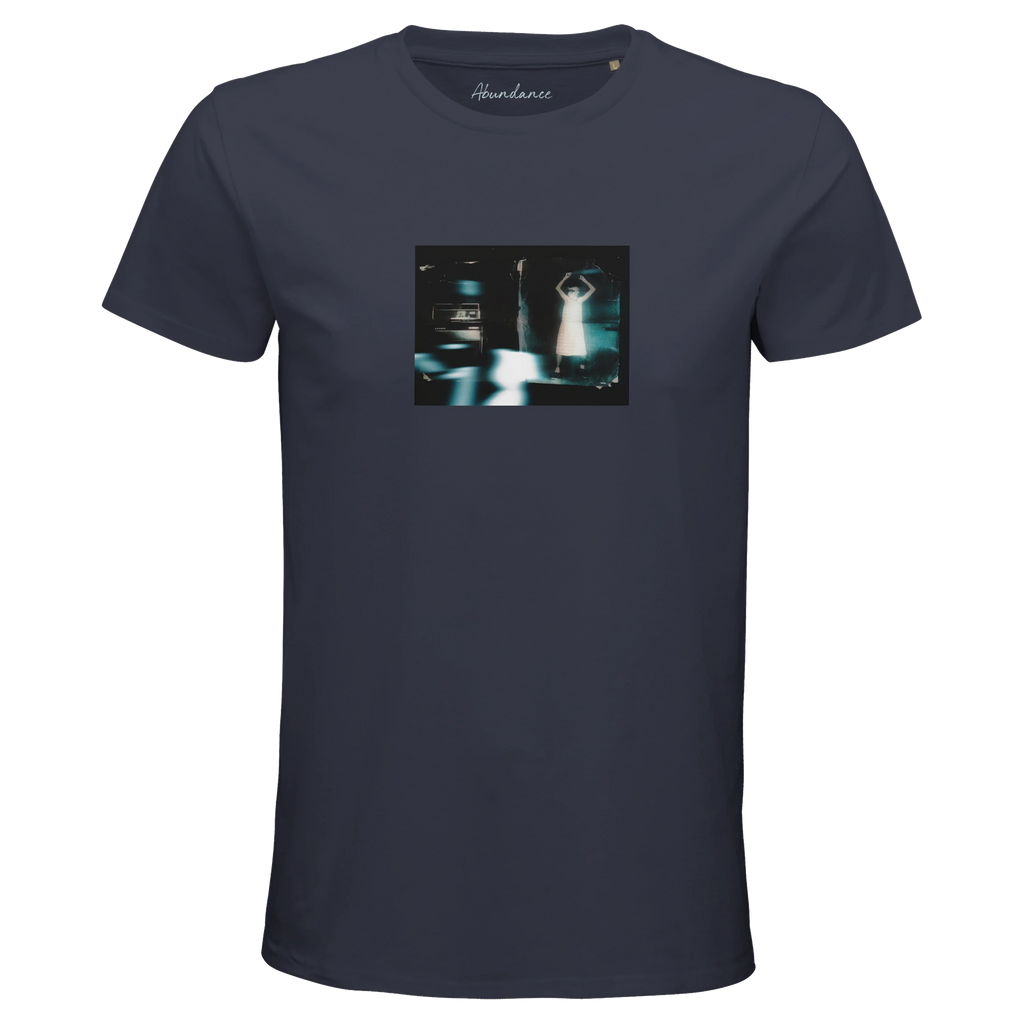 A mouse grey t-shirt with an art print graphic on the chest shows a blurry, dimly lit scene with a standing figure and a car in the background. Mindfully made, it features the Abundance brand name printed inside the neck.