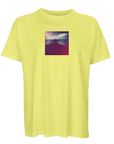 A light yellow short-sleeve t-shirt with a square, colorful photo print of a person by water under a cloudy sky, centered on the chest—designed for conscious fashion enthusiasts.