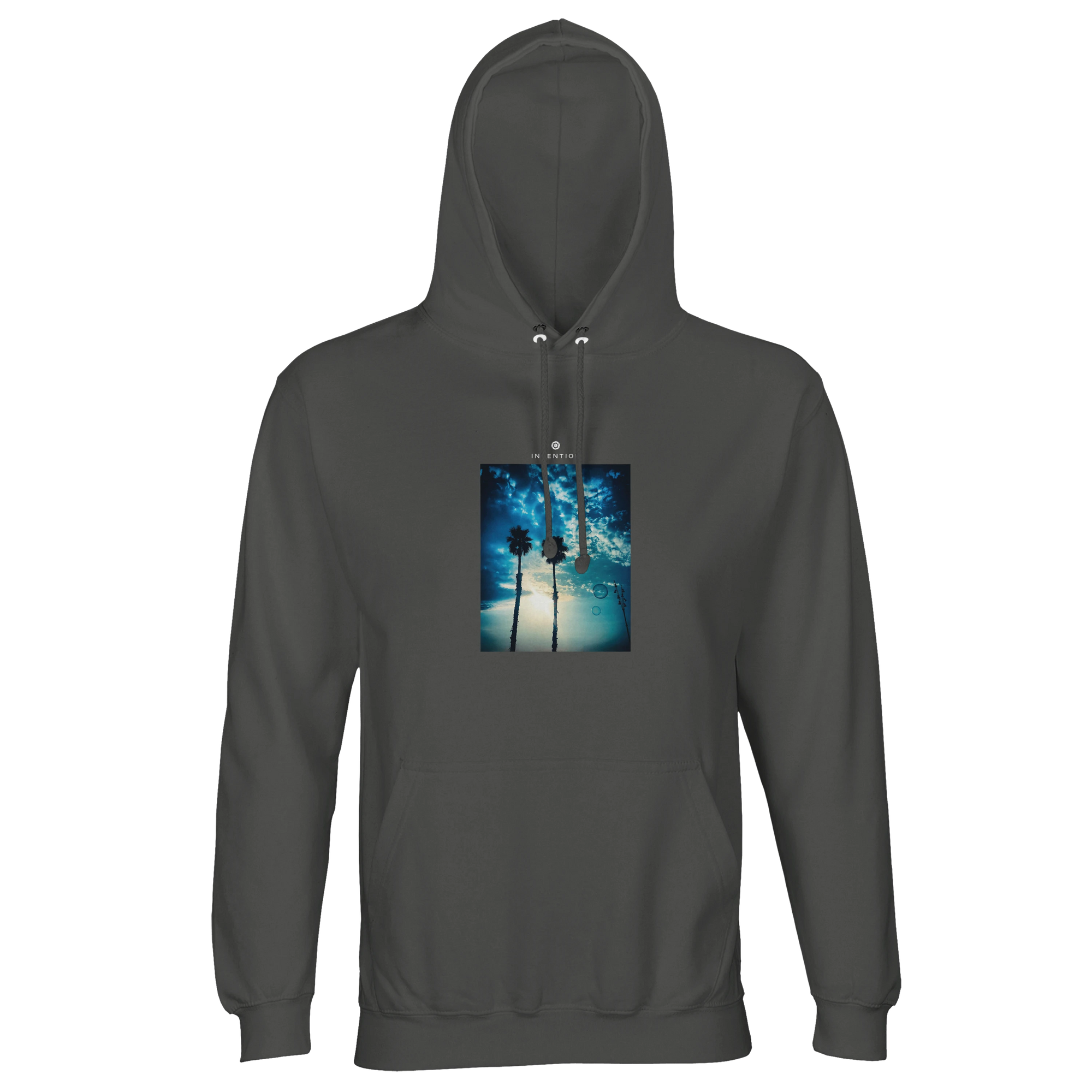 A charcoal melange hooded sweatshirt featuring an art print of two palm trees against a blue sky with sunlight filtering through branches, ideal for fans of mindful apparel.