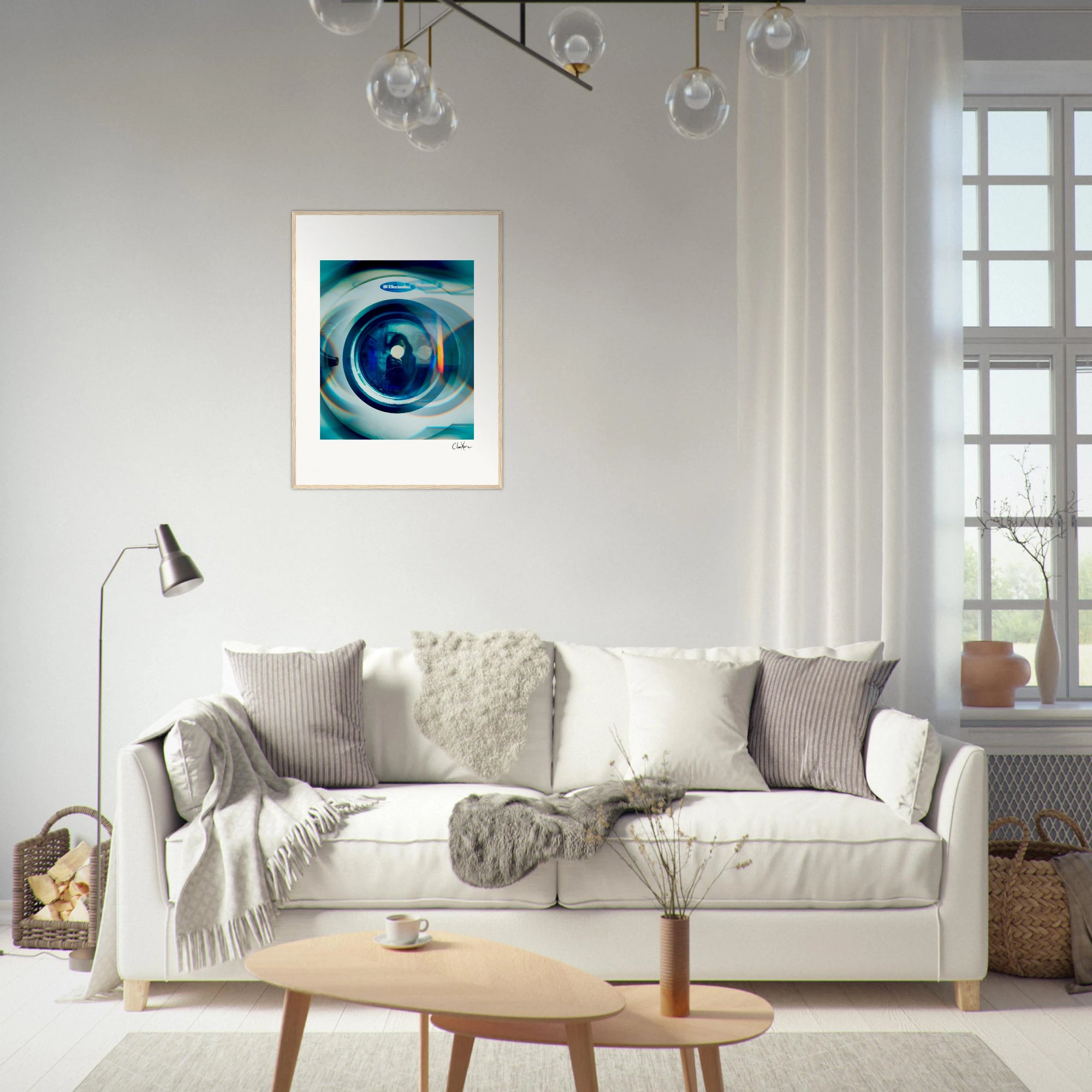 A modern living room featuring a white sofa, gray and beige cushions, a floor lamp, and a small wooden coffee table. Inspirational wall art framed above the sofa adds character, while a large window fills the mindful home decor with natural light.