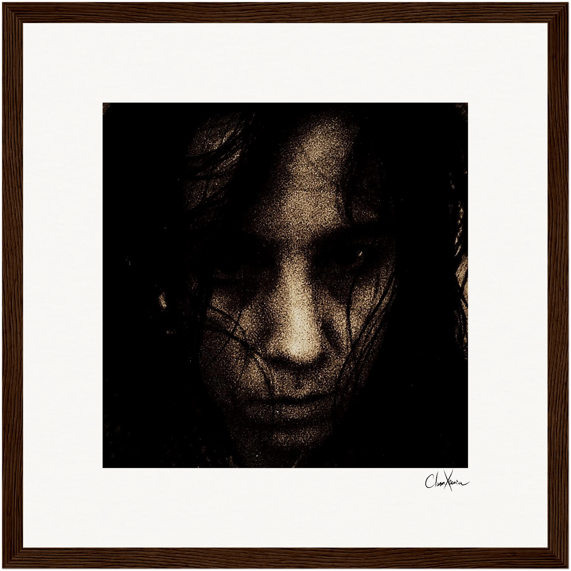 A dark, grainy close-up image of a person's face with long hair partially covering their features, giving a somber and intense expression. The photo comes in a gallery-quality frame and is signed in the bottom right corner.