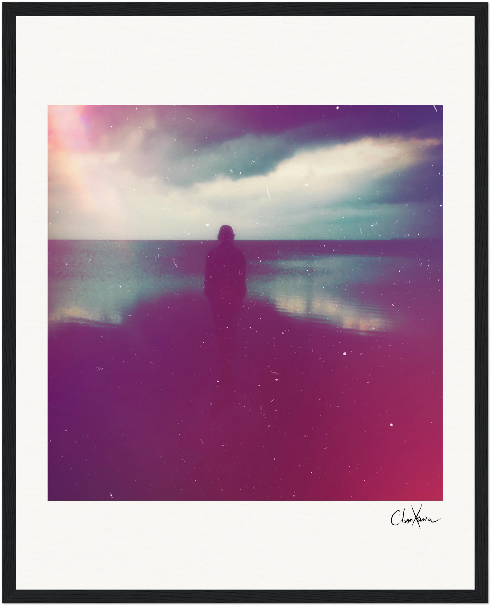 A silhouette of a person stands on a reflective beach beneath a cloudy sky. Pink and purple tints with visible grain and light streaks create a moody atmosphere, perfect as framed wall art for conscious interior design.