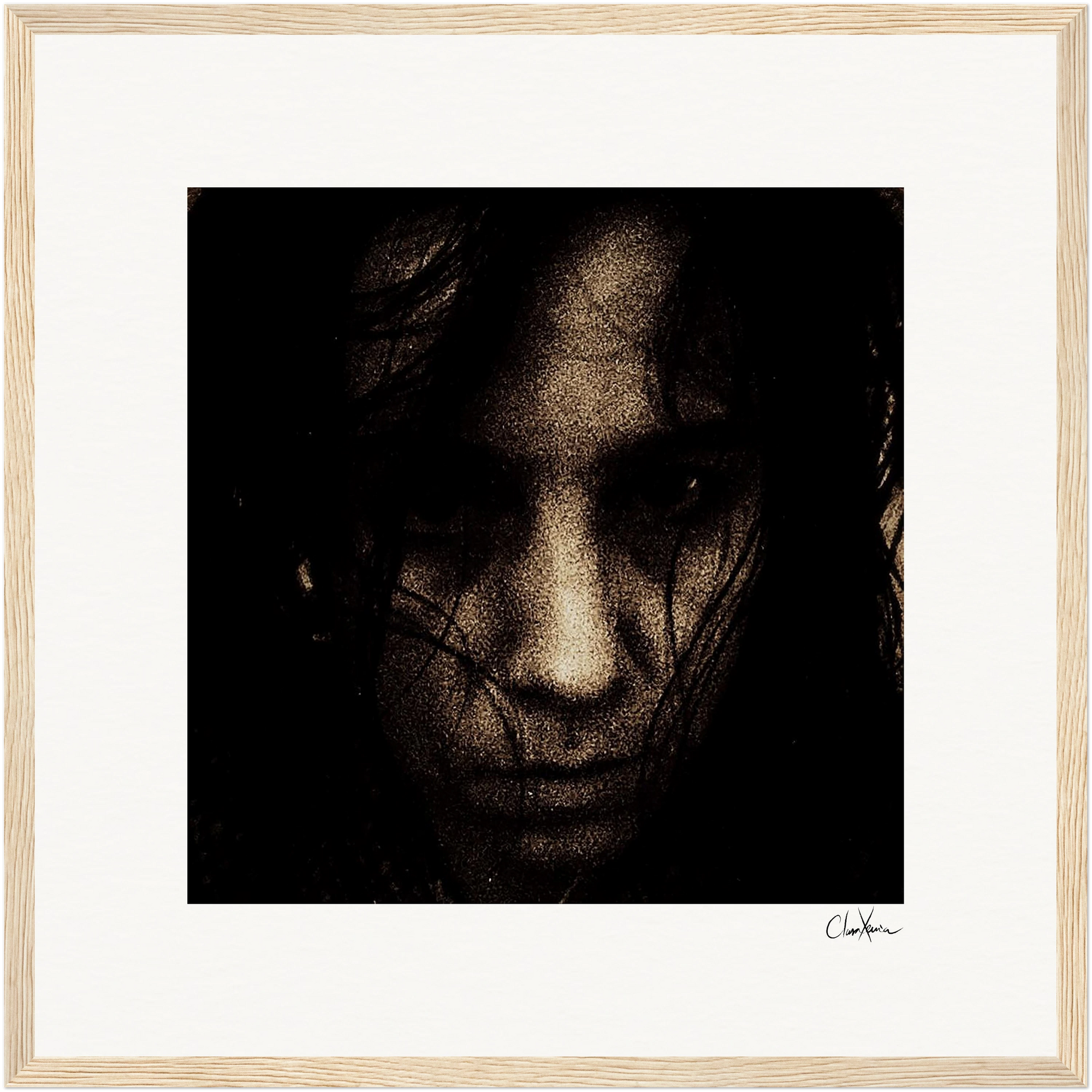 A grainy, high-contrast black and white close-up portrait of a person's face, partially obscured by dark hair. The intense expression and light wood border make it striking framed wall art for conscious interior design.