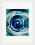 Close-up of a washing machine door with a blue tint, showing reflections and the Electrolux brand label. This fine art print features abstract visual effects and a signature at the bottom right, perfect for conscious interior design.