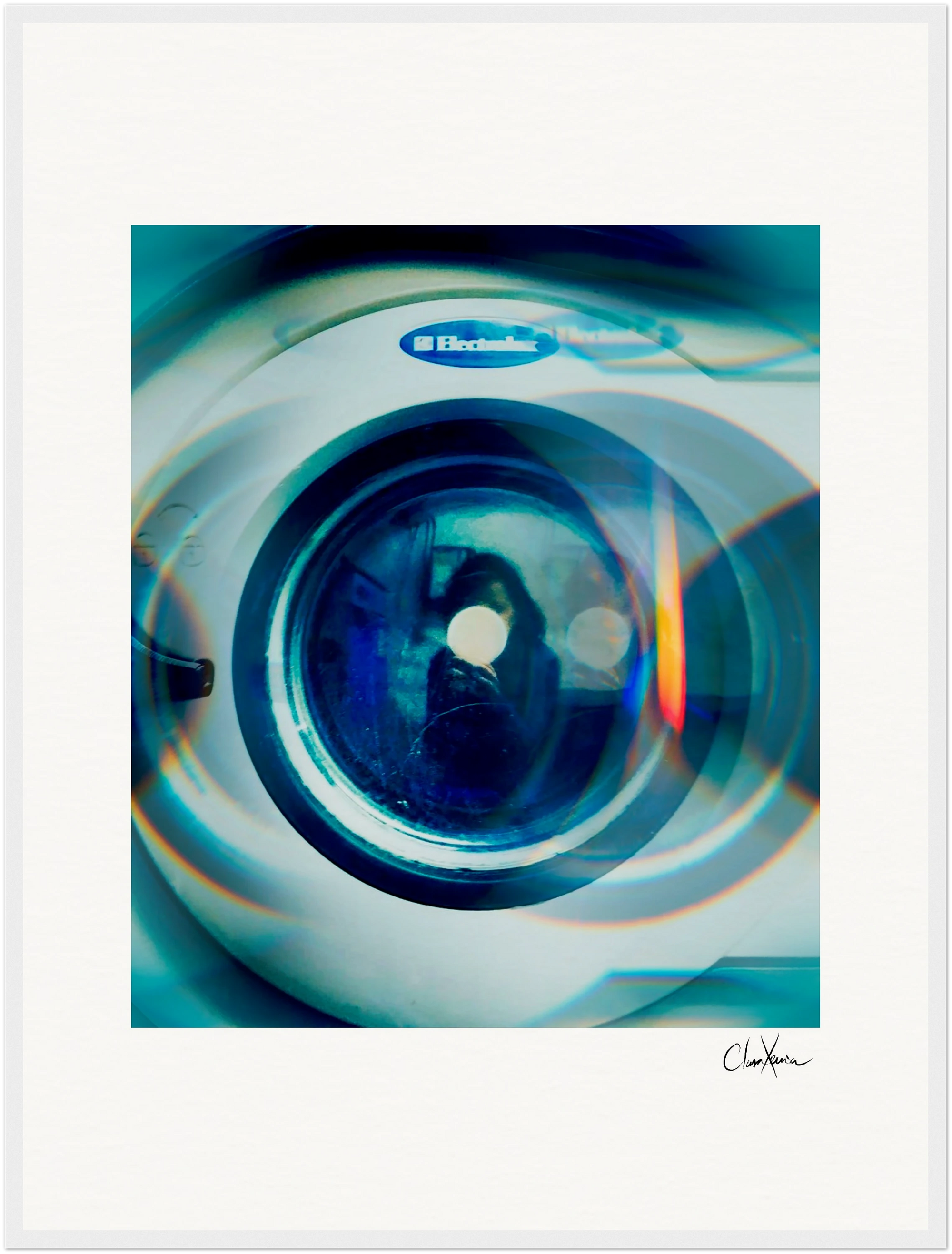 A close-up image of an Electrolux washing machine door features blue and green light reflections with circular patterns on the glass. This fine art print offers a soft, artistic blur, making it ideal as inspirational wall art for a mindful home decor.