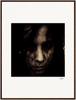 A dark, grainy close-up portrait of a person's face with long hair partially covering their features. The moody, intense image is presented in a gallery-quality frame with a white border, bringing mindful home decor to your space.