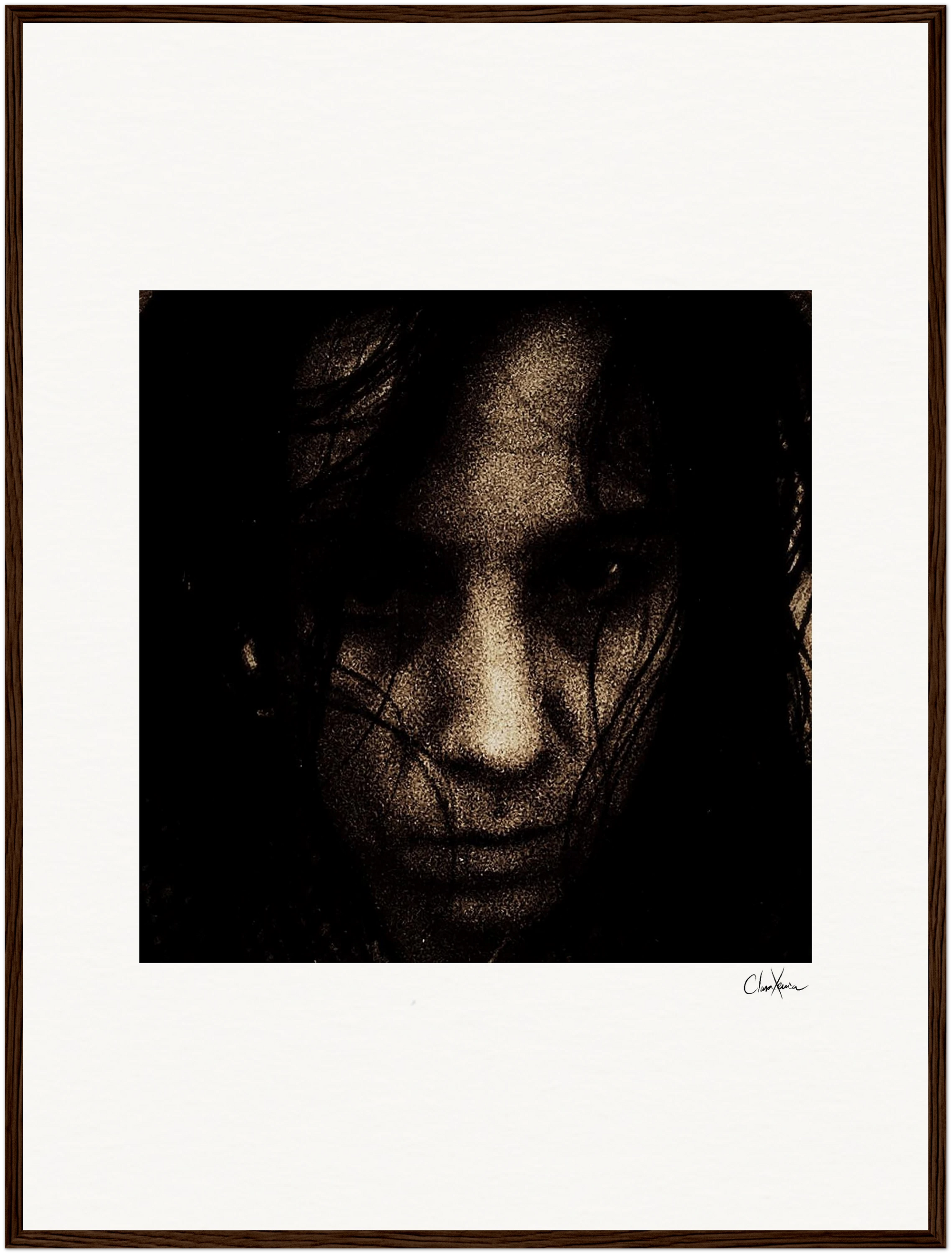 A dark, grainy close-up portrait of a person's face with long hair partially covering their features. The moody, intense image is presented in a gallery-quality frame with a white border, bringing mindful home decor to your space.