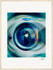A close-up photo of an Electrolux front-loading washing machine door with blue and orange light reflections, presented as a fine art print. The image features a soft blur, a white border, and a gallery-quality frame of light wood.