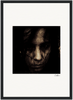 A dark, grainy photograph of a person’s face, partially obscured by shadows and strands of hair, serves as a fine art print. It is centered on a white background with a black border and features a small signature in the lower right corner.