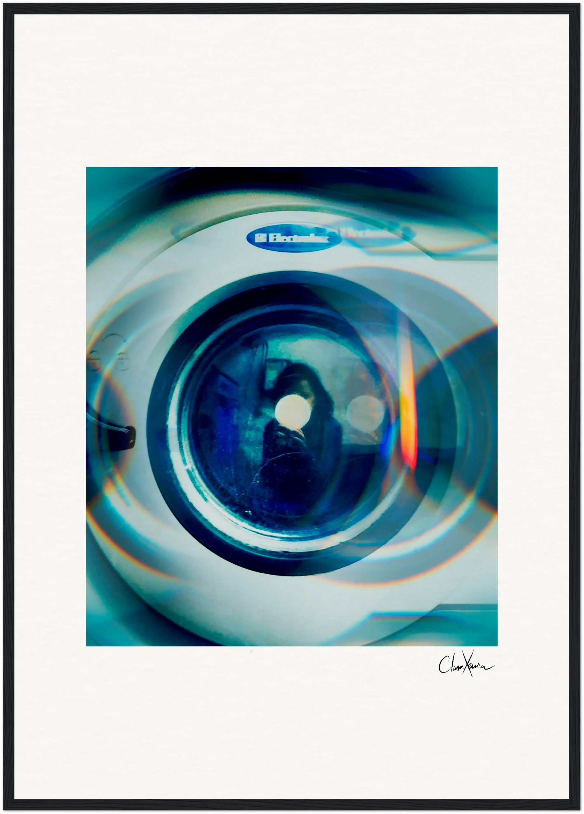A close-up, slightly distorted image of the front door of an Electrolux washing machine, with a blue-green tint and circular light reflections. Perfect as a fine art print for mindful home decor, the artist's signature appears in the lower right corner.
