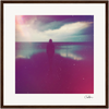 A silhouetted person stands by the water under a cloudy sky, with pink and purple light effects and a grainy texture, presented as a fine art print in a white mat and dark wooden gallery-quality frame—perfect for mindful home decor.
