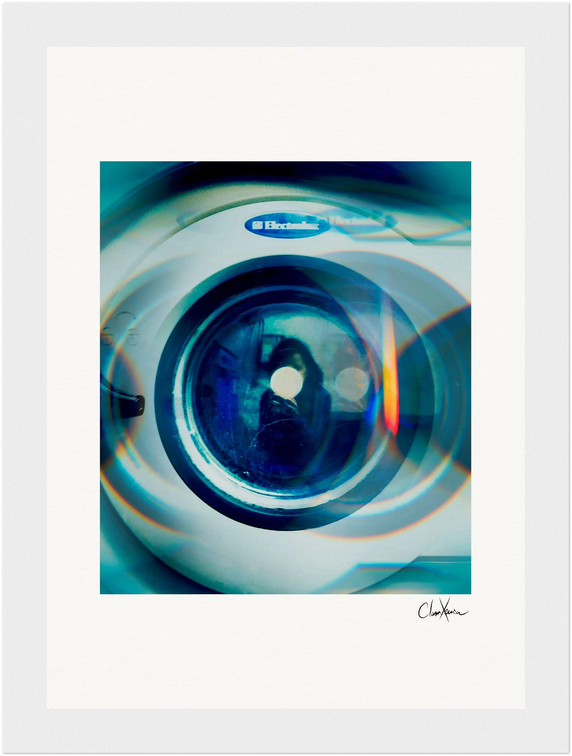A close-up image of the front window of an Electrolux washing machine features reflections and blue-tinted light effects, with an abstract circular pattern—perfect as mindful home decor or an inspirational wall art fine art print.