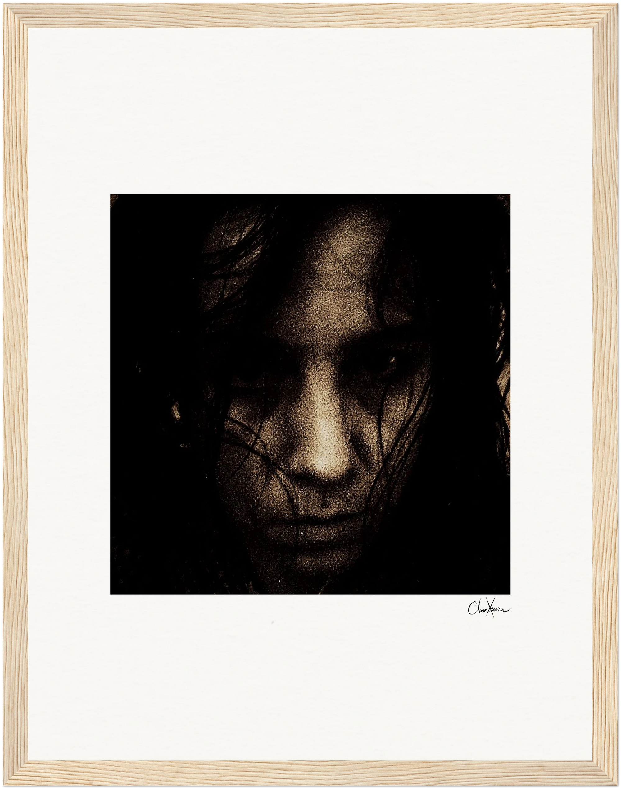 A close-up, grainy portrait of a person with dark hair partially covering their face, set against a black background and framed in a gallery-quality frame. Their expression appears serious and intense—perfect for mindful home decor or as a fine art print.