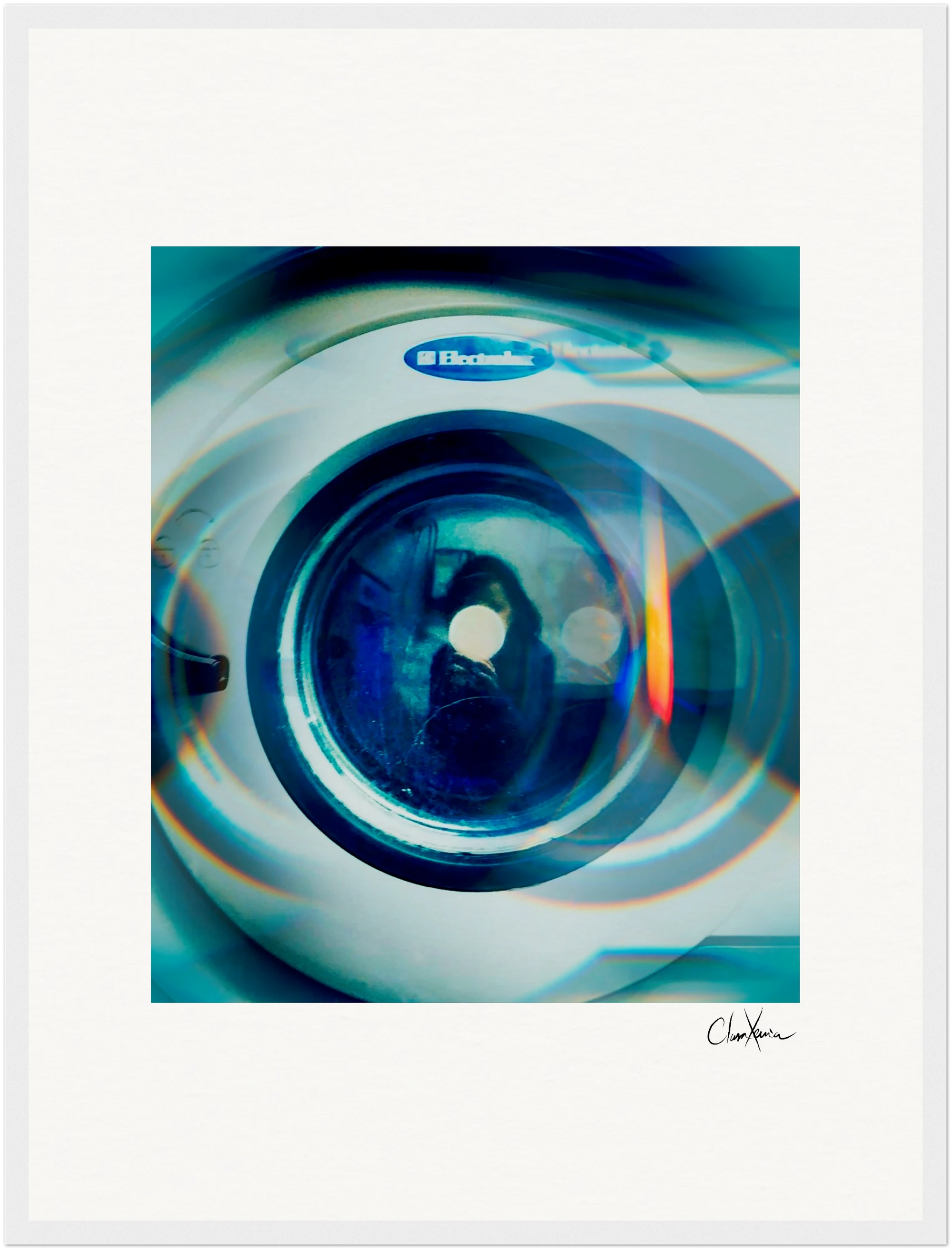 A close-up photo of a washing machine door with a blue-green light effect, featuring the Electrolux logo above. The faint reflection of a person adds intrigue, making this image an ideal fine art print for conscious interior design enthusiasts.