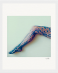 A single outstretched leg in blue and pink floral-patterned lace tights appears against a pale background. The image, perfect for mindful home decor, is softly focused and signed Chxx in the lower right corner.