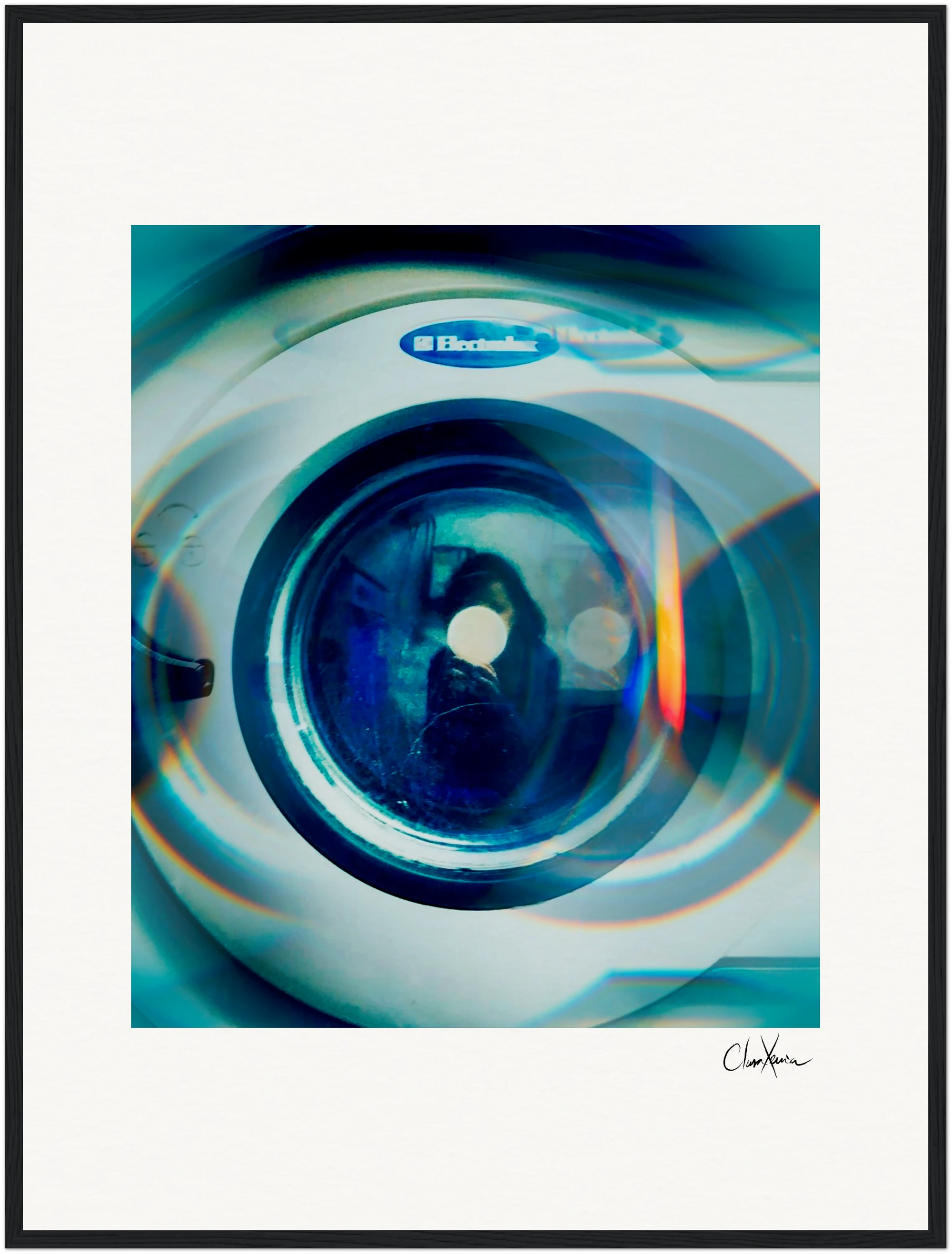 A close-up image of the front door of an Electrolux washing machine, with a blue tint and circular light reflections. This fine art print is framed and signed in the bottom right corner—perfect for conscious interior design.