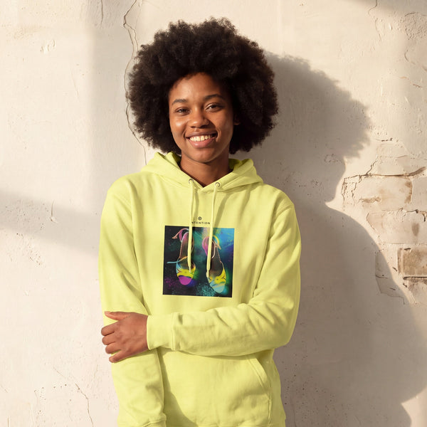 Adventurous - "Dancing in Colours" Light Yellow Hoodie worn against a sunlit plaster wall