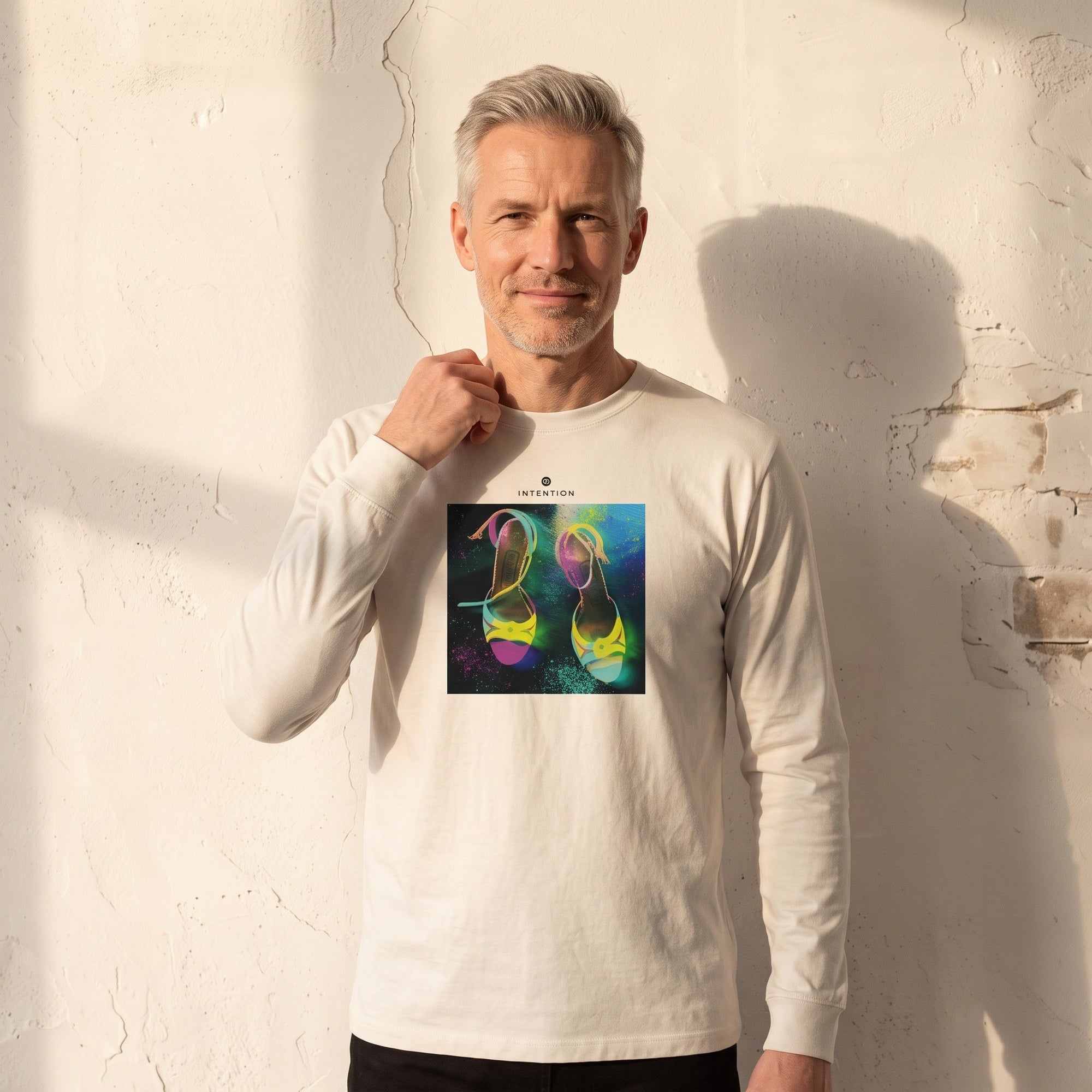 Adventurous - "Dancing in Colours" Off White Long Sleeve worn against a sunlit plaster wall