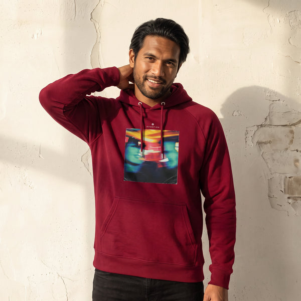Alive - "Moving Smiles" Burgundy Hoodie worn against a sunlit plaster wall