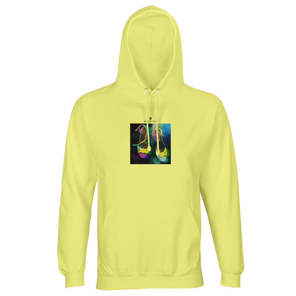 A light yellow hooded sweatshirt with an art print of two colorful high-heeled shoes on an abstract background, ideal for conscious fashion lovers.