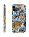 A phone case with a close-up photo art of blue butterflies on green grass, shown from the back and side. The camera cutout is visible, and “INTENTION” is printed near the bottom. Rich textures add depth to this unique art print design.