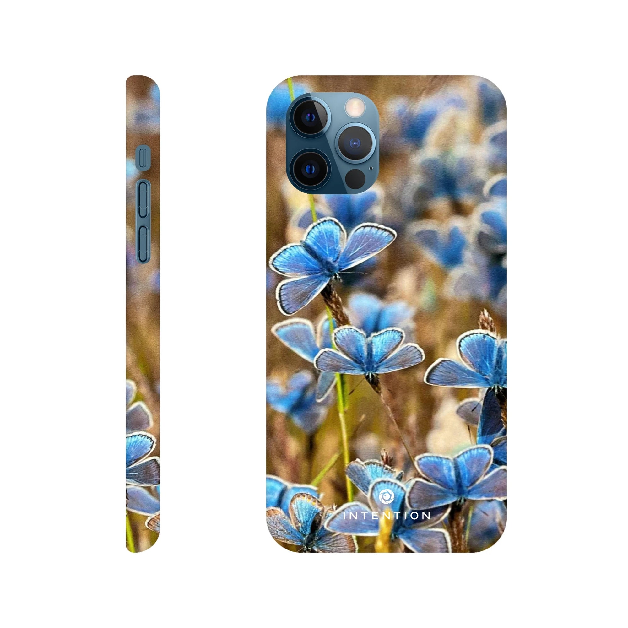 A phone case with a close-up photo art of blue butterflies on green grass, shown from the back and side. The camera cutout is visible, and “INTENTION” is printed near the bottom. Rich textures add depth to this unique art print design.