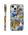 A phone case featuring photo art of blue butterflies on textured brown and green grass. The design covers the back and sides, with the camera and buttons visible. The word INTENTION appears at the bottom.