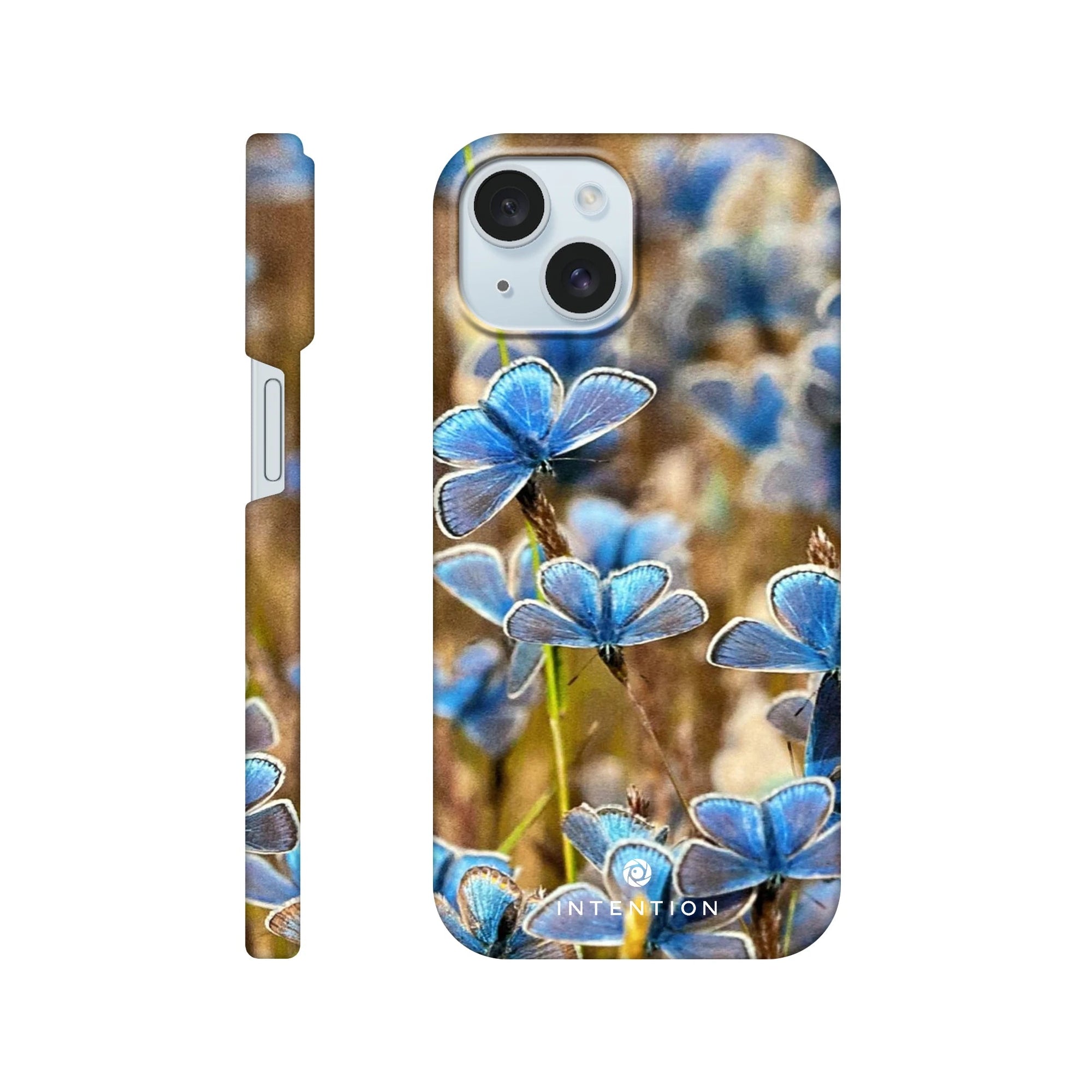 A phone case featuring photo art of blue butterflies on textured brown and green grass. The design covers the back and sides, with the camera and buttons visible. The word INTENTION appears at the bottom.