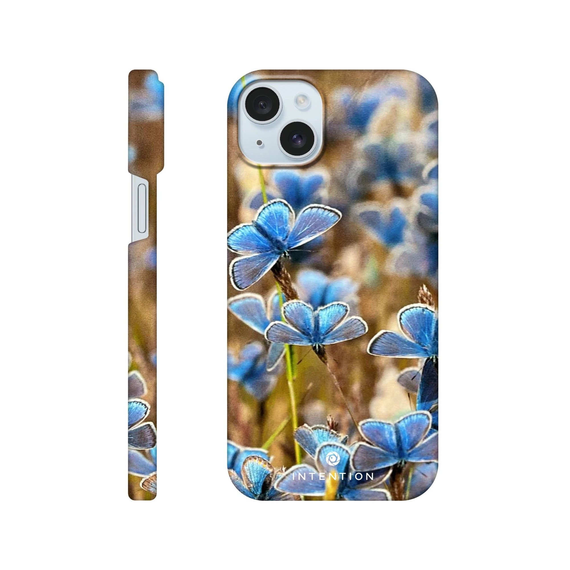 A phone case featuring a close-up photo art of blue butterflies on grass, with the word INTENTION printed near the bottom center. The case displays detailed textures and is shown from both back and side angles.