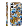 A phone case featuring an art print of blue butterflies on textured green and brown plants, with the word INTENTION in white near the bottom. The camera and side button openings are clearly visible.